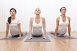 Beschreibung: Interracial Group of Three Beautiful Women In Yoga Position
